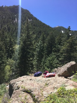 two-hiking-backpacks-on-a-rock-in-the-rocky-mountains-on-a-sunny-day