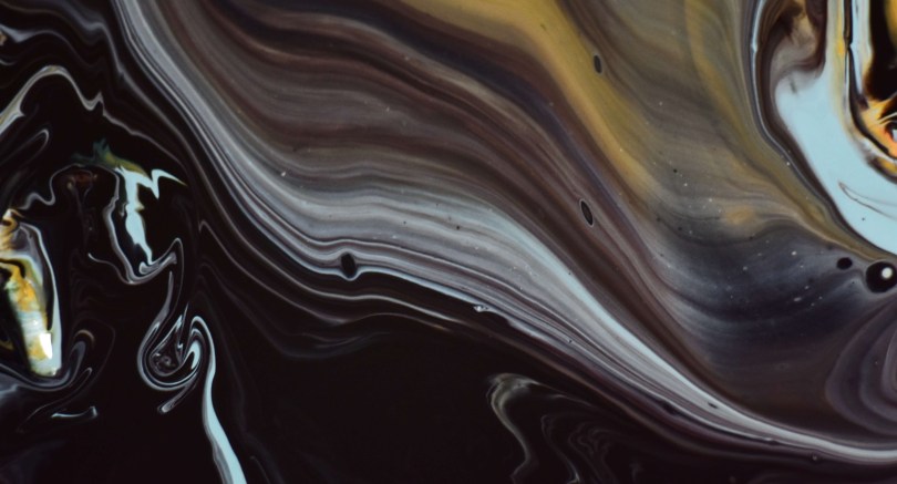 Abstract artwork with brown, tan, and black colors swirled together in layers.