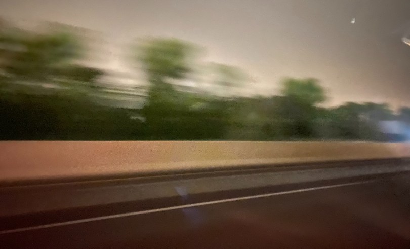 blurry-road-with-green-trees-showing-movement