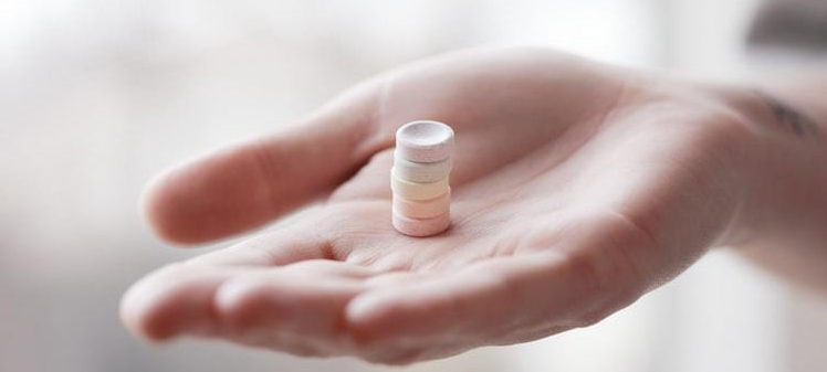 hand-holding-stack-of-smarties-candy-in-palm